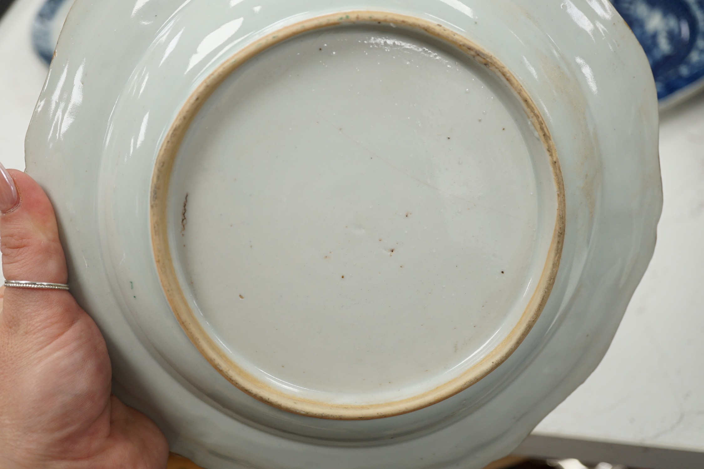 A Chinese export armorial soup plate, for the Spanish market, Qianlong period, with a Spanish coat of arms, possibly Aguado de Las Marismas, an 18th century Chinese export punch bowl on stand, a Chinese blue and white pl